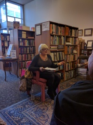 Antonette Rea sharing her work at her poetry reading at Bison Books
